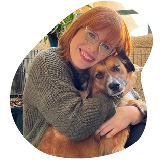 Dog owner hugging her brown dog