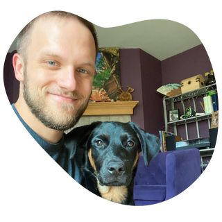 A pet owner and his black and brown dog